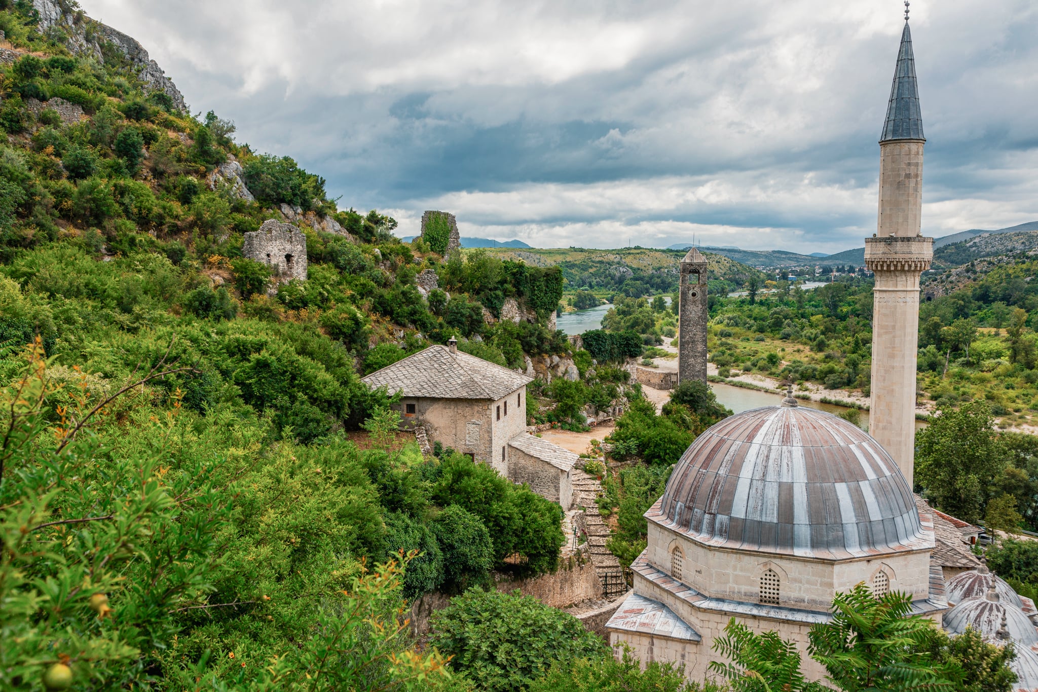 Historic hillside village of Počitelj with stone houses & a medieval tower overlooking the valley