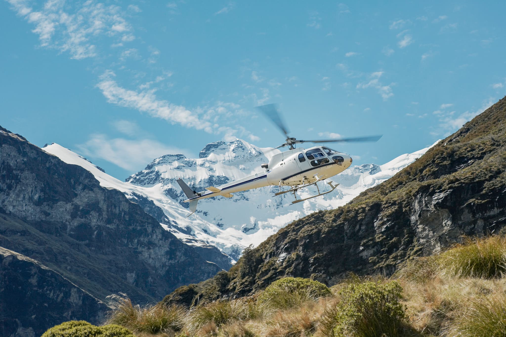 Helicopter flying over mountain
