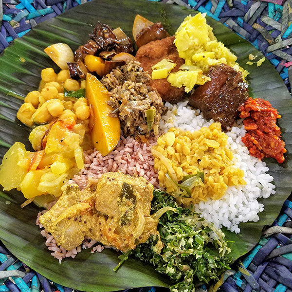 A mixture of Sri Lankan flavors served on a leaf