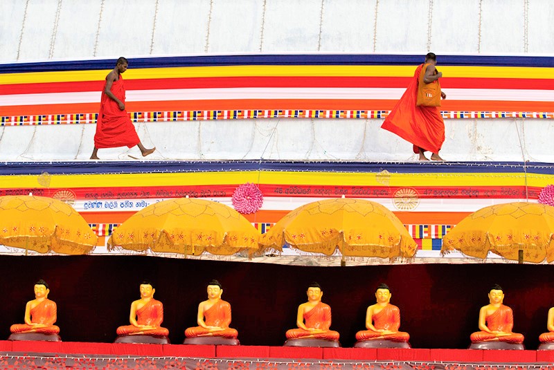 Buddhist monks on a stupa preparing for a ceremony at Anuradhapura, Sri Lanka