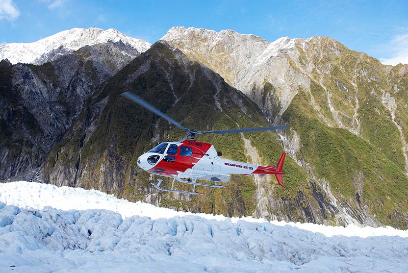 A helicopter lands on Franz Josef Glacier on New Zealand's South Island