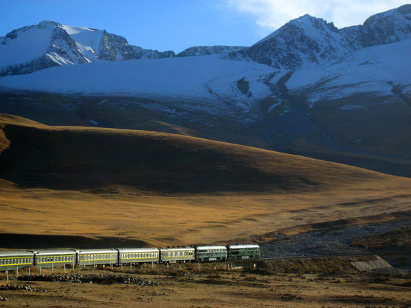 Golden Eagle train driving through mountainous landscape, Silk Road region