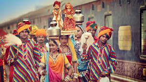 Colorfully dressed locals welcome the Deccan Odyssey train in Jaipur, India with GeoEx