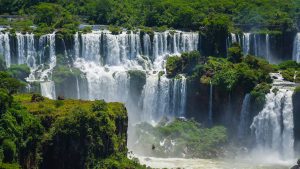 Water cascades down through rain forest vegetation at Iguaza Falls, Argentina