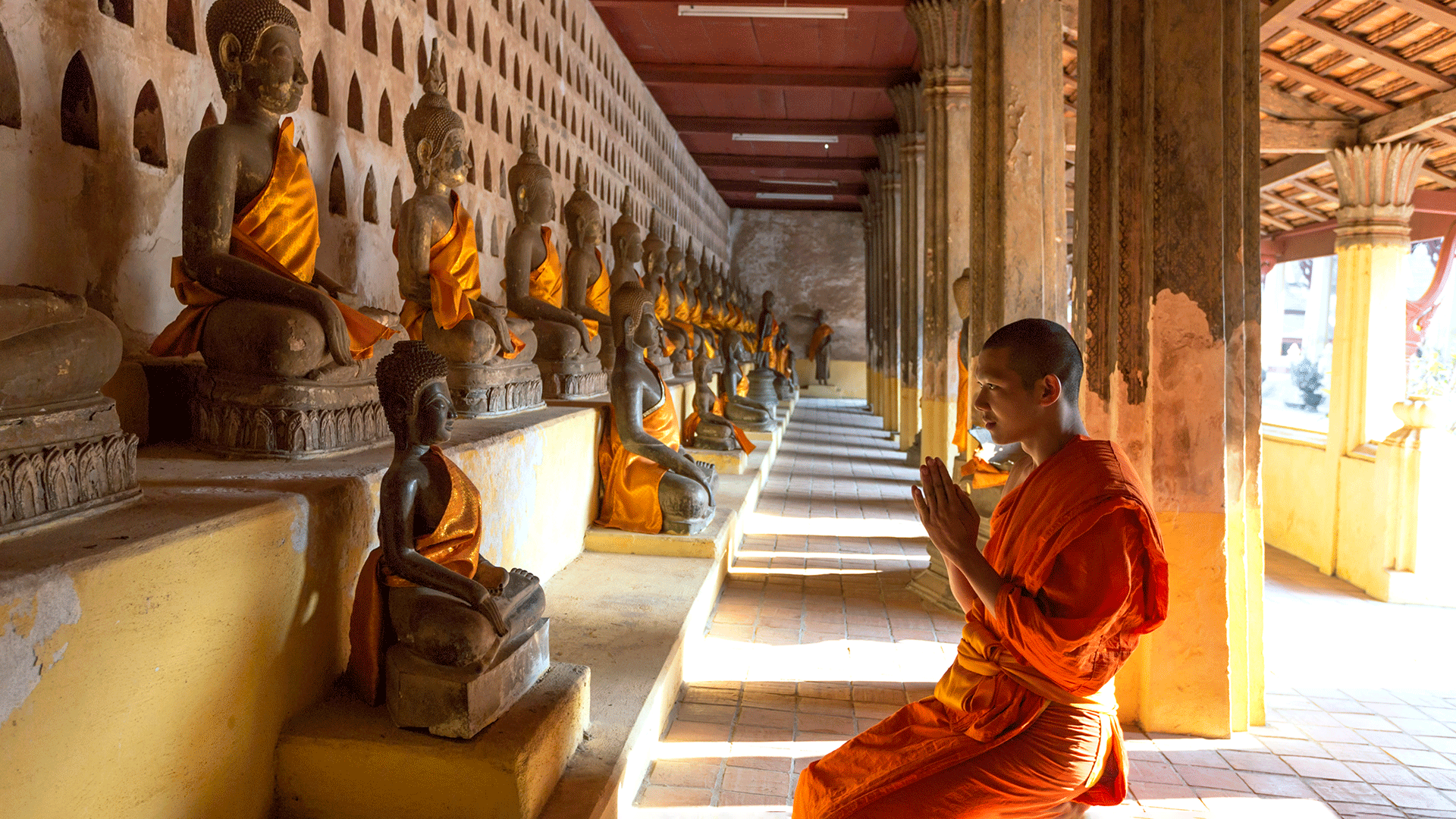 Buddhist monk praying at Wat Sisaket Temple